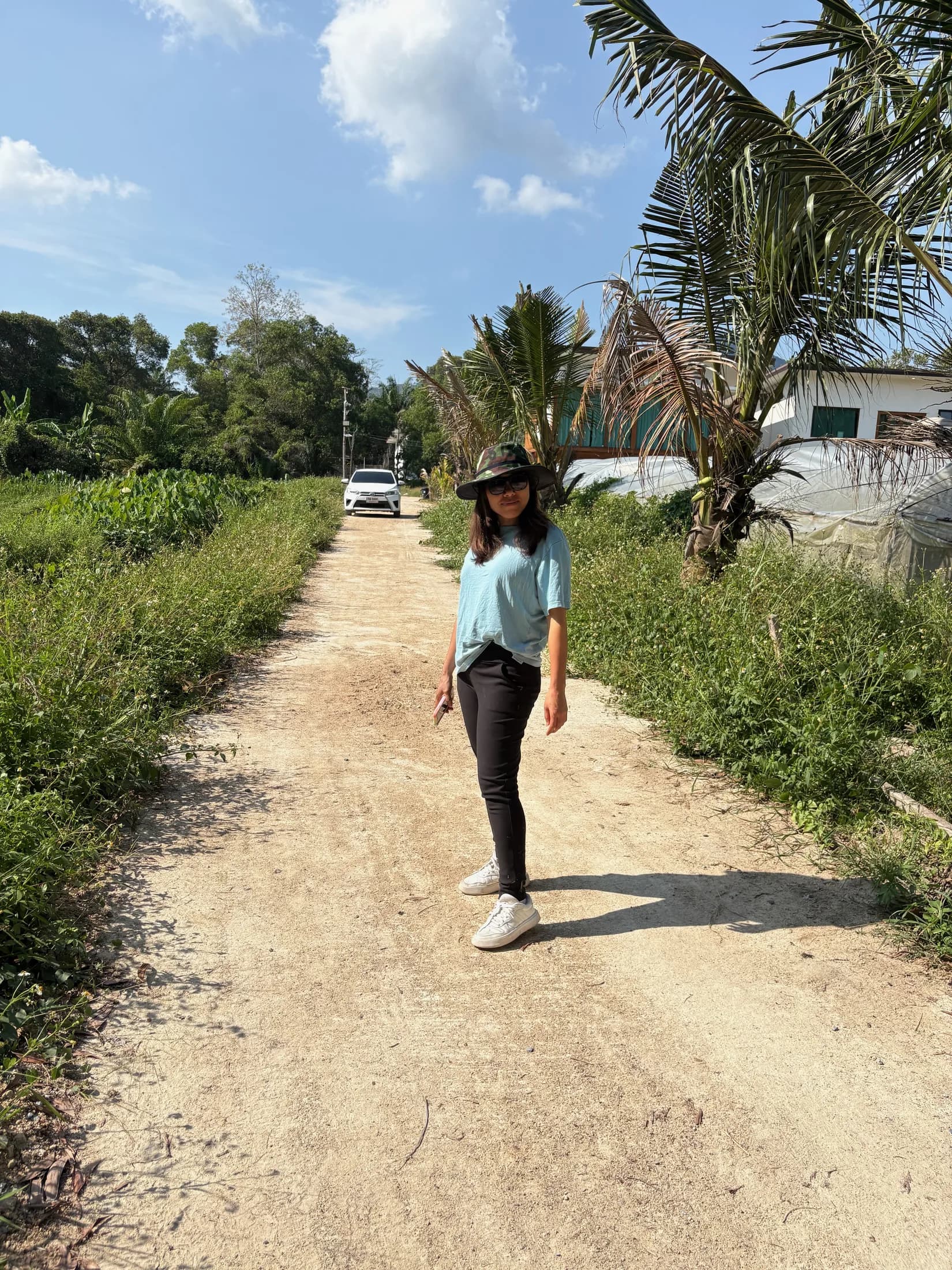 Person walking on access road beside the Wok Tum land